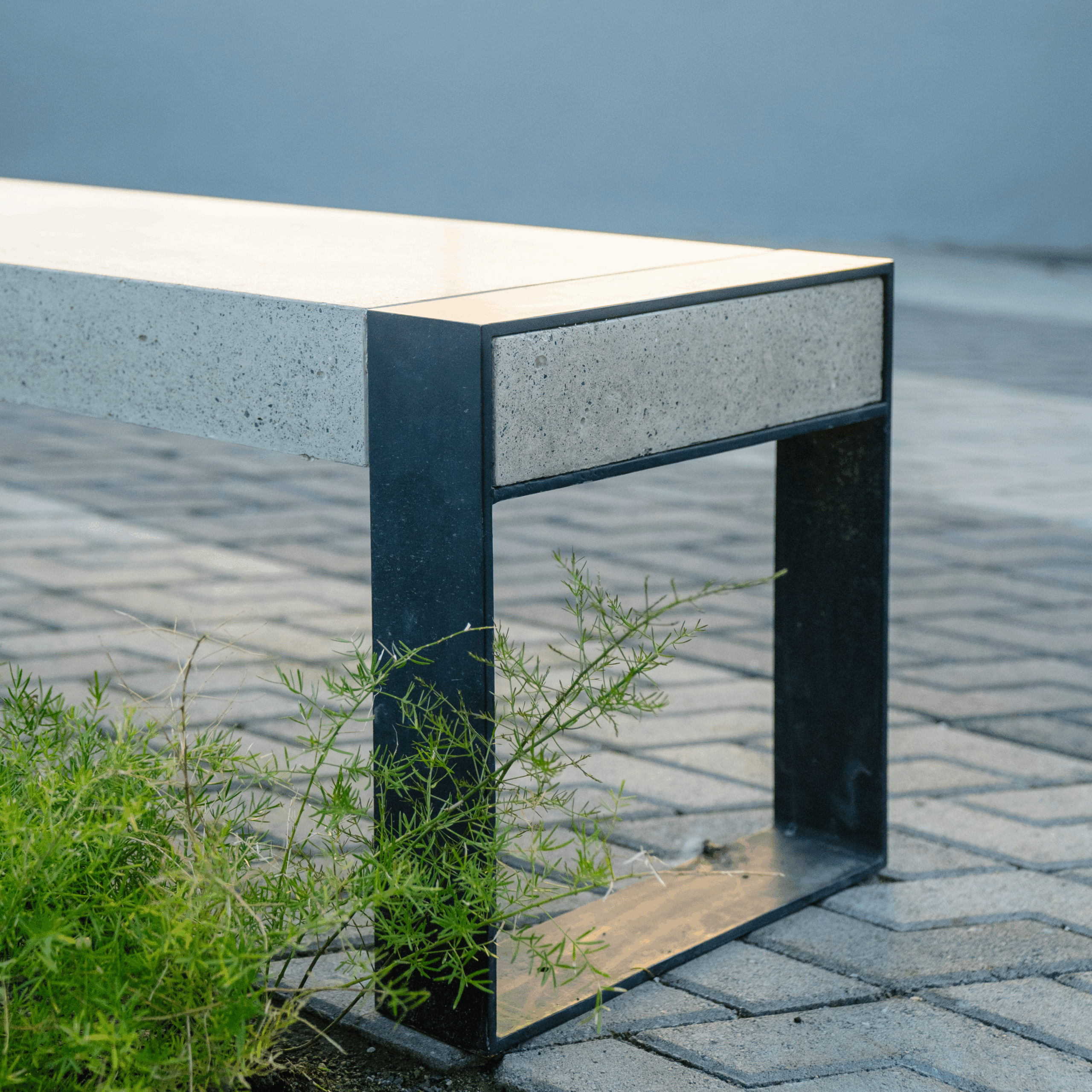 "Modelo de banco urbano elaborado con concreto reforzado y hierro negro"